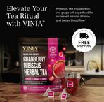 VINIA Cranberry Hibiscus Herbal Tea package and glass cup with tea bags, promoting red grape cell superfood infusion for improved blood flow, arterial dilation, and caffeine-free energy, with free shipping offer.