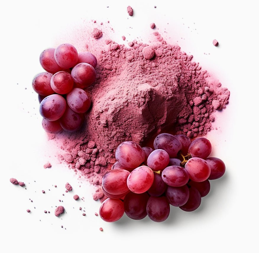 Red grapes and grape powder on a white background